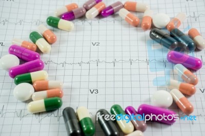 Heap Of Medicine Pills On Cardiogram Grid Paper. Selective Focus… Stock Photo