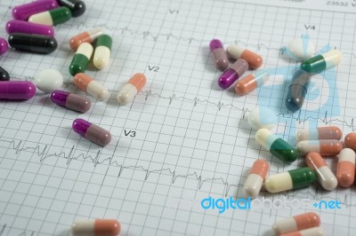 Heap Of Medicine Pills On Cardiogram Grid Paper. Selective Focus… Stock Photo