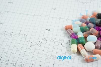 Heap Of Medicine Pills On Cardiogram Grid Paper. Selective Focus… Stock Photo