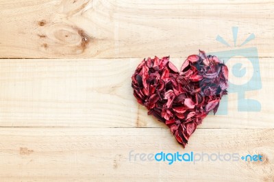 Heart Formed By Red Rose Petals On Wooden Background Stock Photo