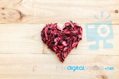 Heart Formed By Red Rose Petals On Wooden Background Stock Photo