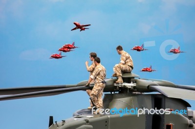 Helicopter Crew Watching The Red Arrows Display Stock Photo