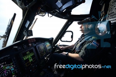 Helicopter Pilot In Flight For Oil Rig Operation Stock Photo