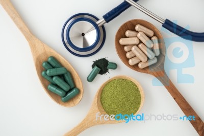 Herbal Medicine In Capsules With Stethoscope On White Stock Photo