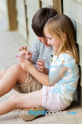 Hhappy Little Brothers With Smartphone In The Park Stock Photo