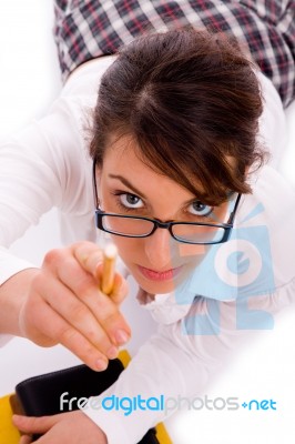 High Angle View Of Female Student Pointing With Pencil Stock Photo