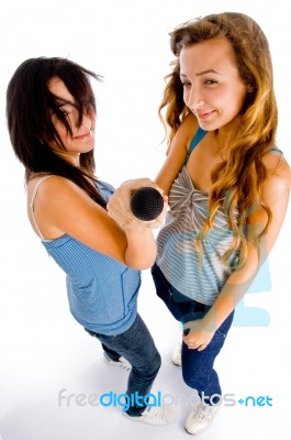 High Angle View Of Females Holding Microphone Stock Photo