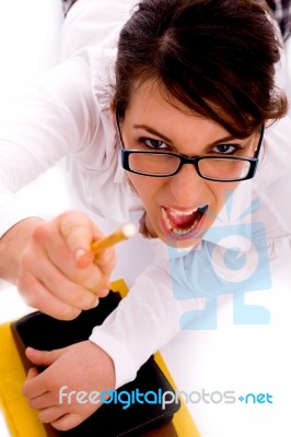 High Angle View Of Shouting Female Pointing With Pencil Stock Photo