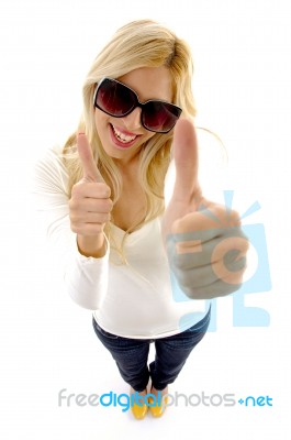 High Angle View Of Smiling Female Model With Thumbs Up Stock Photo