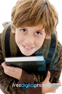 High Angle View Of Smiling School Boy Looking At Camera Stock Photo