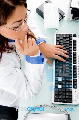 High Angle View Of Working Adult Female Doctor Stock Photo