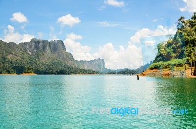 High Mountain Range Above The Green Lake Stock Photo