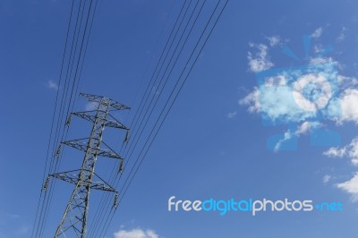 High Voltage Power Pole With Space On Clear Blue Sky Stock Photo