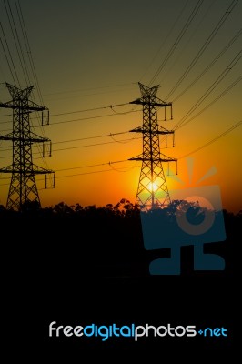 High Voltage Power Tower At Sunset Stock Photo