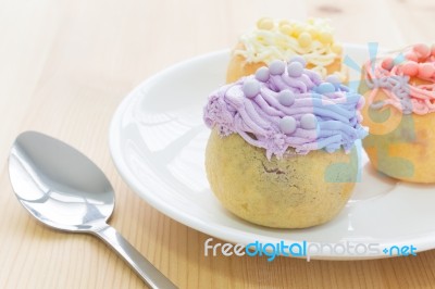 Highlight At Purple Choux Or Profiterole Or Eclair In White Dish And Spoon Stock Photo