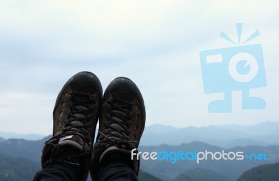 Hiking Shoes In The Mountains And Sky Background Stock Photo