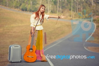 Hippie Girl Hitchhiking Stock Photo