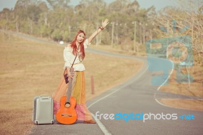 Hippie Girl Hitchhiking Stock Photo