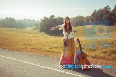 Hippie Girl Hitchhiking Stock Photo