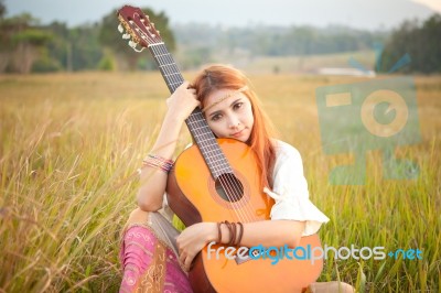 Hippie Girl Playing Guitar On Grass Stock Photo