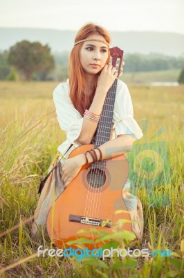 Hippie Girl Playing Guitar On Grass Stock Photo