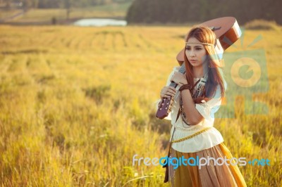 Hippie Woman Walking In Golden Field Stock Photo