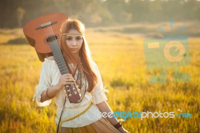 Hippie Woman Walking In Golden Field Stock Photo