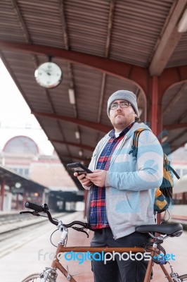 Hipster Young Man Carrying A Bicycle Waiting At Train Station Stock Photo