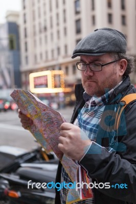 Hipster Young Man Looking The Map In A Urban Scene Stock Photo