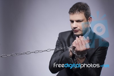 His Hands Are In Chains Stock Photo