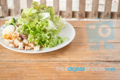 Homemade Salad Serving On Wooden Background Stock Photo