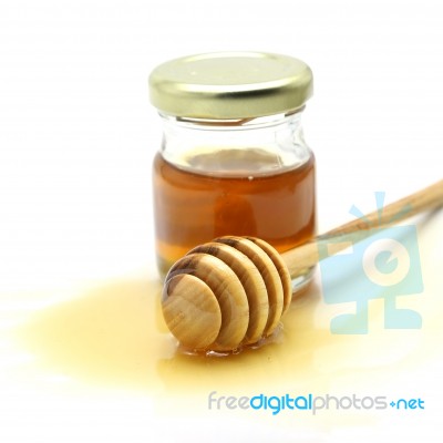 Honey And Dipper On White Background Stock Photo