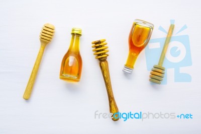 Honey Wooden Dipper And Little Honey Bottle On White Wooden Back… Stock Photo