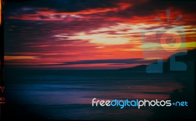 Horizontal Vintage Red Orange Vibrant Sunset Ocean Horizon Motio… Stock Photo