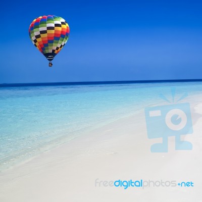 Hot Air Balloon Travel Over The Sea Stock Photo