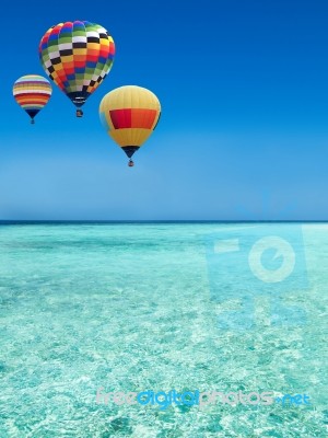 Hot Air Balloons Travel Over The Sea Stock Photo