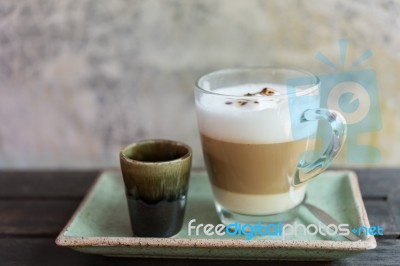 Hot Coffee Latte And Brown Sugar On Green Clay Background Stock Photo