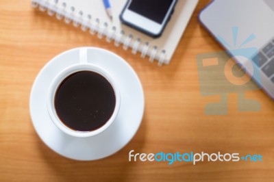 Hot Cup Of Coffee On Working Table Stock Photo