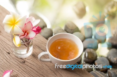 Hot Tea In White Cup With Flowers On Wooden Pebble Stone Water B… Stock Photo