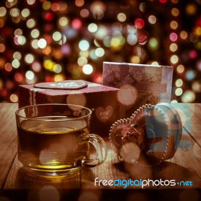 Hot Tea With Gift Box On Wooden Table Stock Photo