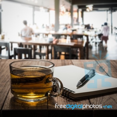 Hot Tea With Notebook And Pen On Wooden Table Stock Photo