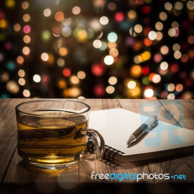 Hot Tea With Notebook And Pen On Wooden Table Stock Photo