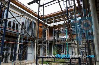 House In Scaffolding Stock Photo