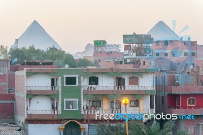 Houses In Cairo And Pyramids Of Giza At The Background Stock Photo