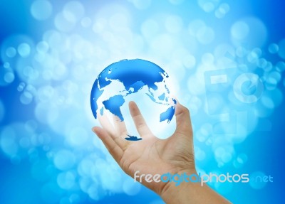 Human Hands Holding Blue Earth On Blue Background Stock Image