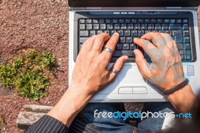 Human Hands Typing A Laptop Stock Photo