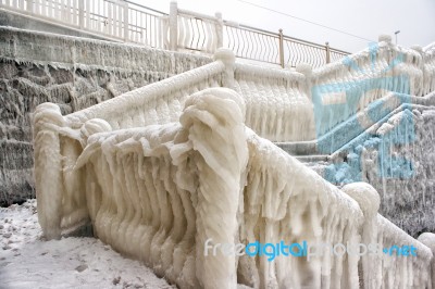 Ice Covered Staircase On The Beach Stock Photo