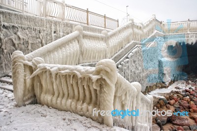 Ice Covered Staircase On The Beach Stock Photo