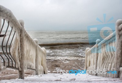 Ice Covered Staircase On The Beach Stock Photo