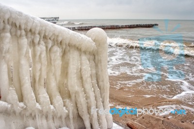 Ice Covered Staircase On The Beach Stock Photo